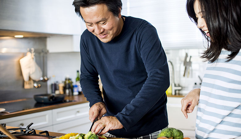 Asian couple cooking in the kitchen